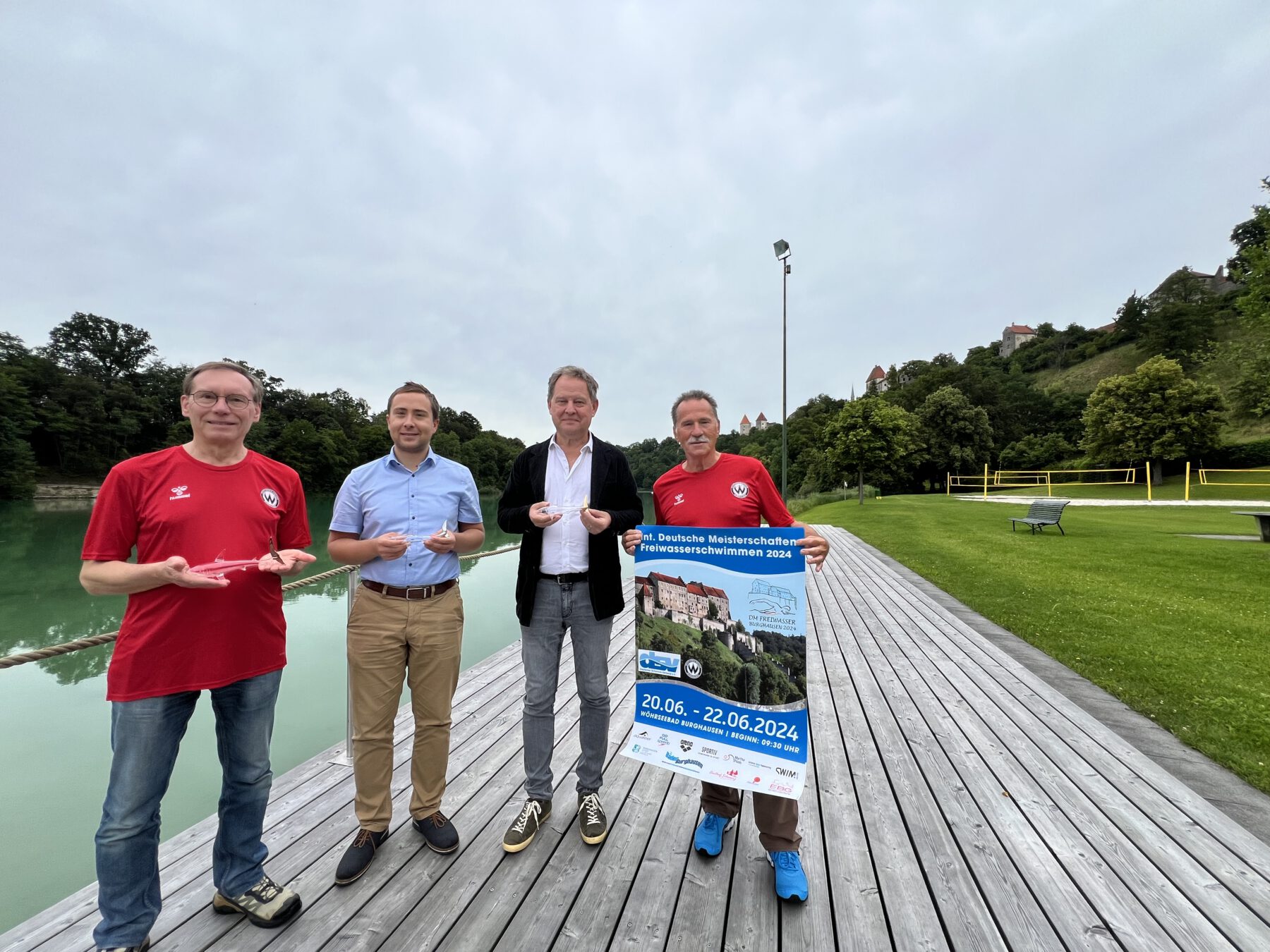 Fotos: Erster Bürgermeister Florian Schneider mit Stefan Hetzer (re.) als sportlicher Leiter bei den Burghauser Schwimmern sowie Volker Mucks (li.) als Abteilungsleiter der Schwimmer des SV Wacker e.V. und Bäderleiter Stefan Sajdak mit den diesjährigen Medaillen: einem Hai aus Glas von Sigi Franz. Fotocredit: Stadt Burghausen / köx